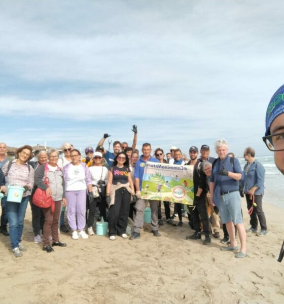 Eco-walk at Ugento's Coastal Park. Group of volunteers cleaning the beach. Environmental awareness and community involvement.