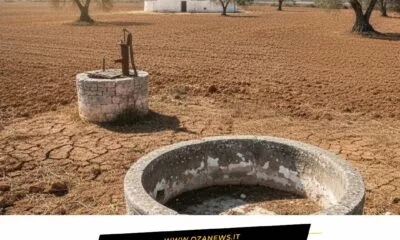 Dry Puglia landscape with cracked earth, wells, and trulli. Drought emergency in Puglia.